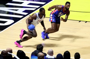 SALT LAKE CITY, UTAH - FEBRUARY 17: Football player DK Metcalf #14 of Team Dwayne dribbles the ball against football player Calvin Johnson #81 of Team Ryan during the first quarter in the 2023 NBA All Star Ruffles Celebrity Game at Vivint Arena on February 17, 2023 in Salt Lake City, Utah. NOTE TO USER: User expressly acknowledges and agrees that, by downloading and or using this photograph, User is consenting to the terms and conditions of the Getty Images License Agreement. (Photo by Tim Nwachukwu/Getty Images)