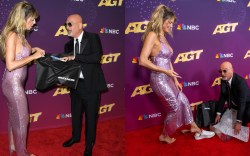 Howie Mandel gifts Heidi Klum a pair of Skechers on the "America's Got Talent" Season 19 finale red carpet.