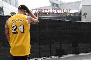 Gennesys Cabral, of Los Angeles, wears a Kobe Bryant jersey outside of the Staples Center at the 62nd annual Grammy Awards, in Los Angeles. Bryant died Sunday in a helicopter crash near Calabasas, Calif. He was 41Kobe Bryant, Los Angeles, USA - 26 Jan 2020