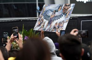 Fans take photos of artwork featuring former Los Angeles Lakers basketball player Kobe Bryant outside of the Staples Center prior to the start of the 62nd annual Grammy Awards at the Staples Center, in Los Angeles. Bryant died Sunday in a helicopter crash near Calabasas, Calif. He was 41
Kobe Bryant, Los Angeles, USA - 26 Jan 2020