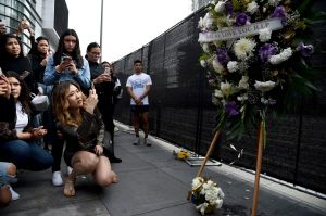 People gather near a makeshift memorial for former NBA basketball player Kobe Bryant outside of the Staples Center prior to the start of the 62nd annual Grammy Awards at the Staples Center, in Los Angeles. Bryant died Sunday in a helicopter crash near Calabasas, Calif. He was 41
Kobe Bryant, Los Angeles, USA - 26 Jan 2020