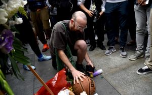 Newman Wolf places a basketball at a makeshift memorial for the late Kobe Bryant outside of the Staples Center prior to the start of the 62nd annual Grammy Awards, in Los Angeles. Bryant died Sunday in a helicopter crash near Calabasas, Calif. He was 41
Kobe Bryant, Los Angeles, USA - 26 Jan 2020