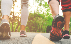 Low Section Of People Wearing Sports Clothing While Walking On Road